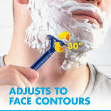 Blue disposable razor held in hand, pivoting head shaving over lathered skin