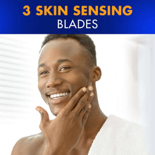 Blue refillable razor being used on skin, held near the cheek.