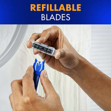 Blue refillable razor handle with blade cartridge, held by a hand.