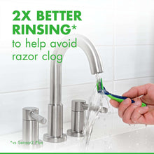 Disposable razor rinsed under running water, green handle near faucet