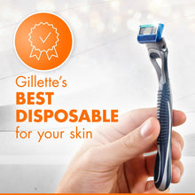 Men's disposable razor held in hand, blue handle and silver blade cartridge