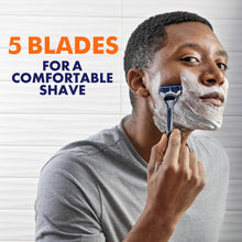 Men’s disposable razor shaving face with white foam, blue handle near cheek