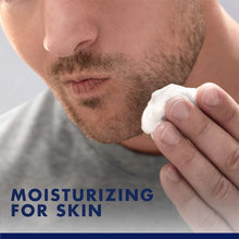 Shaving foam smoothing on cheek with hand