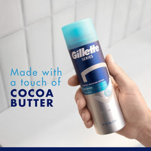 Shave gel can in hand with teal cap