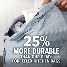 Tall kitchen trash bag in hand, blue patterned bag with drawstring top