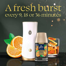 Glade automatic spray air freshener device with gold refill canister and orange accents