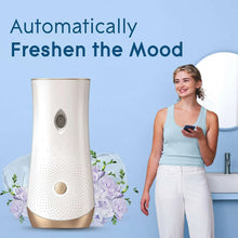 Automatic spray air freshener device with gold top, shown with floral accents and a bottle sprayer