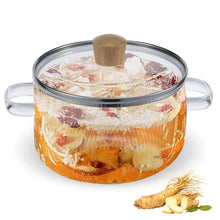 Glass cooking pot with lid, clear ribbed body, two handles, contents inside
