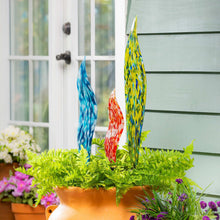 Set of 3 glass garden stakes with blue, red, and yellow mosaic swirls in greenery.