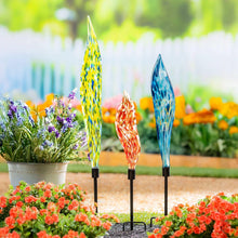 Set of 3 glass garden stakes in blue, yellow, and orange swirls with black holders.