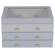 Gray lift-top jewelry box with three drawers and gold round knobs, open compartment inside