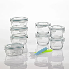 Set of clear glass baby food containers with light blue lids, stacked for storage