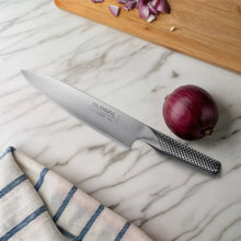 Chef's knife with stainless blade and textured perforated handle