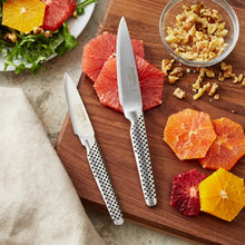 Global Classic paring knife pair with pointed stainless blades and perforated, speckled handles