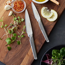 Global Classic paring knives with stainless blades and perforated speckled handle grips