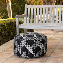 Geometric stripe round pouf with black fabric and white diagonal lines