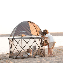 Gray mesh toddler playard with dome canopy and teal interior base for outdoor use