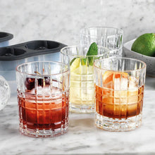 Whiskey chiller cups with faceted glass sides, showing red, yellow, and clear chilling contents