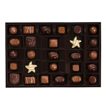 Assorted chocolate box with tray of mixed chocolates, including star-shaped piece