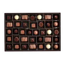 Open assorted chocolate box tray with mixed dark and white chocolates
