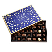 Assorted chocolate box with open lid, blue patterned cover and mixed chocolates