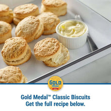 Biscuits on a metal tray with small cup of butter