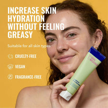Lightweight daily moisturizer tube held by cheek, mint green with blue top.
