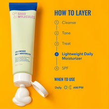 Lightweight daily moisturizer tube beside white cream dollop, screw cap removed.