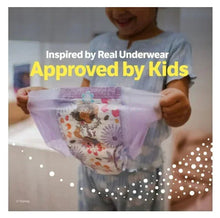 Child holding white printed Goodnites underwear with colorful animal and star graphics