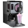 Soft serve ice cream maker dispensing pink drink into a clear glass