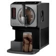 Soft serve ice cream maker with chocolate drink in a clear glass