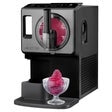 Soft serve ice cream maker dispensing pink slush into a coupe-style glass