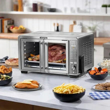 Stainless steel countertop air fryer oven with two compartments; roast meat and vegetables inside.