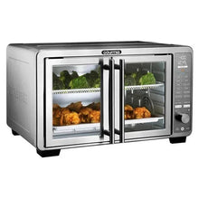 Stainless steel countertop air fryer oven with dual racks; chicken and broccoli inside.