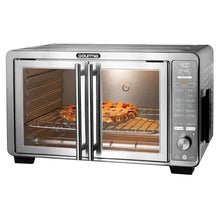 Stainless steel countertop air fryer oven with two cooking chambers; roasts and vegetables inside.