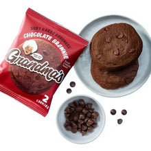 Chocolate brownie cookie set: red packet, two dark cookies, and chocolate pieces