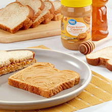 Creamy peanut & honey spread on bread slices with honey roasted spread jar