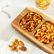 Cajun trail mix in wooden bowls with roasted nuts and corn snacks
