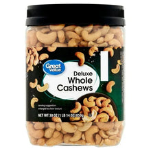 Jar of whole cashews with black lid, light tan nuts
