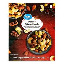 Deluxe mixed nuts pouch with bowl of assorted nuts on red background