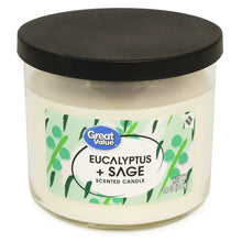 Eucalyptus + sage scented candle in clear glass jar with black lid, front label