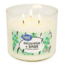 Great Value eucalyptus & sage scented candle, clear jar, green leaf label, three wicks lit