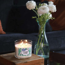 Great Value eucalyptus & sage scented candle in clear jar with green leaf label, flame