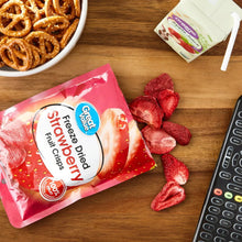 Freeze-dried strawberry fruit crisps pieces with an unopened bag on a table
