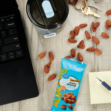 Roasted lightly salted almonds pouch with scattered almonds on a tabletop