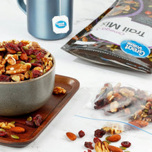 Trail mix in a bowl with nuts and dried fruit, plus a sealed omega-3 bag