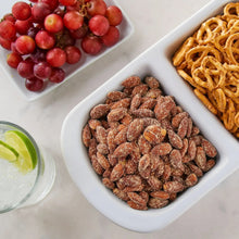 Wasabi soy almonds in a white dish, dark coated almonds with crunchy texture