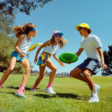 Green flying disk toy being passed during kids' play