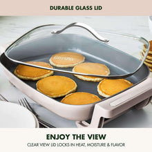 Electric ceramic nonstick skillet with glass lid over pancakes