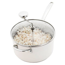 Stainless steel popcorn popper with glass lid, stirring rod, and white handle